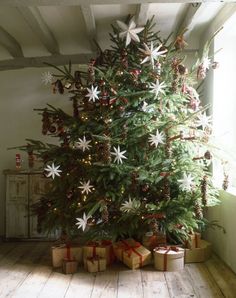 a christmas tree with presents under it