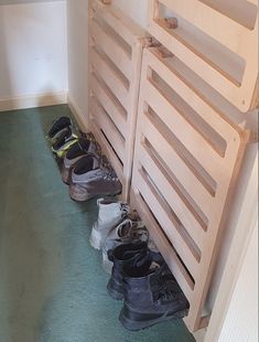 several pairs of shoes are lined up against the wall