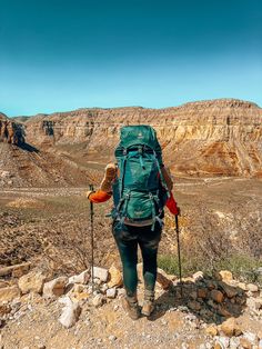 a person hiking in the mountains with backpack and ski poles