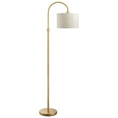 a gold floor lamp with a white shade