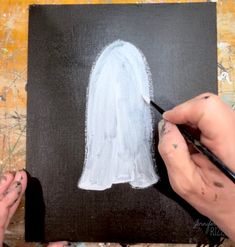 someone is painting the outline of a ghost