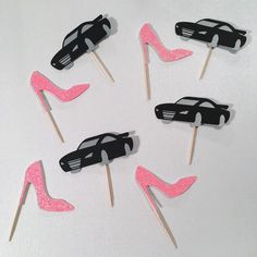 pink and black cake toppers with high heel shoes on them