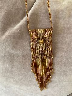 This is a vintage beaded mini Purse Necklace Medicine Pouch Handmade in Guatemala from the 1990's by members of the Mayan communities in rural Guatemala. Created with glass beads. Each one was handmade by members of various Mayan ethnic groups located throughout Guatemala. Handmade Brown Rectangular Necklaces, Bohemian Rectangular Necklaces For Everyday Use, Bohemian Rectangular Necklace For Everyday Use, Bohemian Rectangular Necklace, Everyday Rectangular Bohemian Necklace, Everyday Beaded Necklaces With Round Beads, Rectangular Beaded Necklace For Gift, Rectangular Beaded Necklace Gift, Handmade Beaded Necklaces With Round Beads For Everyday