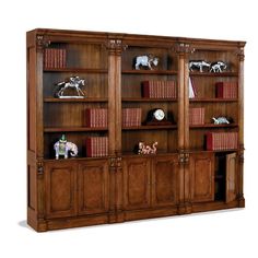 a wooden bookcase with books and figurines on the top shelf in front of it