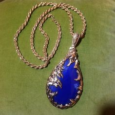 This is a very unique Vintage necklace from the 1960's.   It is gold tone costume jewelry.   The pendant is 4 3/4 inches long including the bail.   It has a cobalt blue teardrop shaped stone. This is the same style pendant that the main character, Elaine wore in the movie "The Love Witch". The chain measures 26 inches and has a clasp. Thank you for taking the time to visit my shop and supporting my small business. The Black Cat Closet is a one-woman operation that has been around since 1999. Please do not hesitate to contact me with any questions. Take a look at more of my unique Vintage and handmade items by following this link: https://www.etsy.com/shop/theblackcatcloset Egyptian Prom, Cat Closet, The Love Witch, Witch Necklace, Nails Jewelry, 1960's Fashion, Witch Jewelry, The Black Cat, Modernist Jewelry