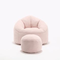 a pink chair and ottoman sitting next to each other