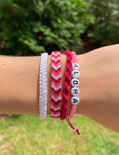 two bracelets with the word hope written on them are shown in front of a tree