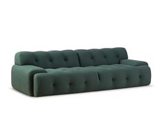 a green couch sitting on top of a white floor