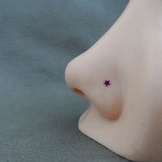 a small purple star is placed on the side of a white mannequin's head