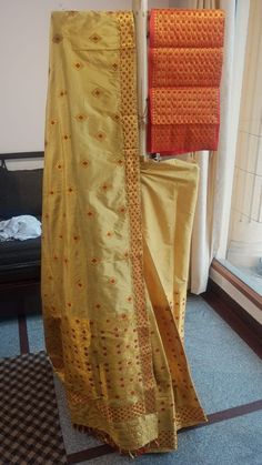 Welcome to our shop, where we take pride in offering you the finest craftsmanship and exquisite textiles. Introducing our pure Muga silk Mekhela Chador, a timeless masterpiece that beautifully combines tradition and elegance. Handwoven with care and precision, this Mekhela Chador is crafted from pure Muga silk, sourced from the silkworm Antheraea assamensis, which is indigenous to Assam, India. Muga silk is known for its lustrous golden hue, unparalleled sheen, and incredible durability. It is c Festive Handloom Pre-draped Saree For Puja, Gold Pre-draped Saree With Traditional Patterns For Festivals, Traditional Semi-stitched Salwar Kameez With Zari Weaving, Festive Pre-draped Saree In Paithani Silk With Traditional Patterns, Transitional Pre-draped Saree With Cutdana For Traditional Ceremonies, Traditional Pre-draped Saree For Ceremonies, Festive Pre-draped Saree With Traditional Patterns, Festive Tussar Silk Pre-draped Saree With Traditional Patterns, Traditional Pre-draped Paithani Silk Saree