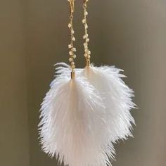 White feather and pearl earrings fresh water pearl long drop image 2 Gold Feather Earrings For Party, Gold Feathered Jewelry For Parties, Gold Feather Jewelry For Wedding, Gold Feathered Wedding Jewelry, White Feather Dangle Earrings, Elegant Feather Jewelry Gift, Elegant Feather Jewelry As Gift, Elegant Feather Jewelry For Gift, Elegant Feather Dangle Earrings