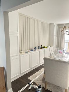 a dining room with white walls and wood flooring is being painted in the process of remodeling