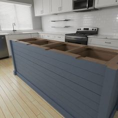 an image of a kitchen setting with white cabinets and wood flooring on the island