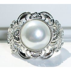 Nwot Sterling Silver Ring, Sizes 9 And 10 Only. This Beautiful Women's Fashion Ring Has A Large 10 (Mm) Mother Of Pearl In An Inlay Setting In The Center With Beautiful Filigree Detailing Around It. This Ring Is 16.8 (Mm) Wide At Its Widest Point, Is Stamped 925 And Has A Rhodium Finish For Greater Shine And Durability. Comes From A Smoke Free Home. White Filigree Promise Ring, Elegant White Filigree Ring With Intricate Design, Ornate Filigree Ring For Promise, Ornate Filigree Promise Ring, Elegant Adjustable Filigree Ring For Formal Occasions, Formal White Filigree Ring, Elegant Wedding Filigree Ring, White Sterling Silver Filigree Ring, Classic Silver Adjustable Filigree Ring