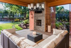 an outdoor living room with fireplace and patio furniture