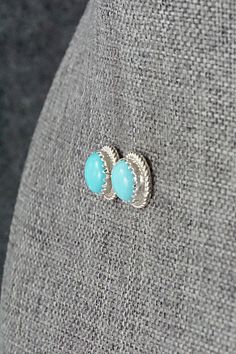 These Campitos turquoise and sterling silver earrings were made by Navajo silversmith Sally Arviso.Length: 7/16" (11mm)Width: 7/16" (11mm)Free shipping on all orders! We ship with USPS and always include tracking. All orders ship within a day of payment.Returns are accepted up to 30 days after you receive your order. Just send us a message. Our shop offers cash back or store credit. The item must be returned in new condition. Sterling Silver Turquoise Cabochon Earrings, Bear Carving, Pearl Chain, Native American Jewelry, Turquoise Sterling Silver, Free Jewelry, White Vintage, Sterling Silver Earrings, Silver Earrings