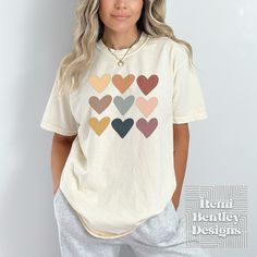 Express your love for all things Boho with our Boho style heart soft-washed Comfort Colors® t-shirt for women! Featuring a distressed graphic of rows of beautiful boho colored hearts, this trendy oversized tee is perfect for any heart lover. Crafted with a soft-washed finish, this comfortable t-shirt is a must-have addition to any wardrobe. Add it to yours today! **Please read the full description so you understand our products and printing process.** FEATURES Medium fabric (6.1 oz/yd² (206.8g/m Heart Graphic Tee For Everyday Wear, Heart Graphic Tee For Everyday, Everyday Graphic Tee With Heart Graphic, Everyday Heart Graphic Tee, Cute Relaxed Fit Top With Heart Print, Trendy T-shirt With Heart Graphic For Everyday, Trendy Relaxed Fit Top With Heart Print, Everyday Cotton Tops With Heart Graphic, Everyday Cotton Top With Heart Graphic