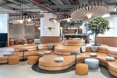 an office lobby with circular seating and plants