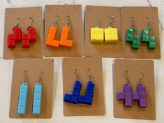 3D printed earrings inspired by Tetris. Originally designed as a gift for my wife to honor her favorite game, these are assembled by our daughter. Earrings are 3D printed using PLA - a plastic made from renewable resources like corn. Hooks are stainless steel and include a silicone earring back. 3d Printer Earrings, Tetris Earrings, 3d Print Jewelry, 3d Printing Jewelry, 3d Printer Jewelry, 3d Earrings, 3d Printed Earrings, Printed Earrings, 3d Printing Diy