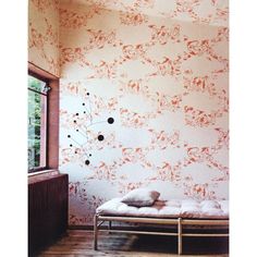 a bed sitting in front of a window next to a wall with animals on it