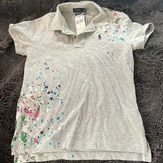 Polo Ralph Lauren Grey Splatter Paint Shirt With Tags Casual Paint Splatter Tops For Summer, Casual Multicolor Paint Splatter T-shirt, Multicolor Paint Splatter Casual T-shirt, Casual Short Sleeve Paint Splatter Top, Casual Short Sleeve Tops With Paint Splatter, Casual Paint Splatter Top For Spring, Casual Spring Tops With Paint Splatter, Spring Short Sleeve Tops With Paint Splatter, Spring Paint Splatter Short Sleeve Tops