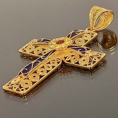 Byzantine style Cross made of 18 ct. solid yellow gold The Cross consists of two different pieces, the basic Cross which is decorated with different sizes filigree work spirals, and the upper part, the second Cross Has a flower in the center and is adorned with blue and red enamel The cross is made in Greece, in one of the oldest goldsmith workshops that specializes in making filigree An amazing handmade byzantine cross that can be a special gift for any special occasion ( The price does not inc Traditional Ceremonial Intaglio Jewelry, Antique Yellow Gold Jewelry With Meenakari, Yellow Gold Meenakari Jewelry Gift, Antique Meenakari Jewelry Gift, Antique Meenakari Jewelry As A Gift, Luxury Handmade Enamel Jewelry, Formal Enamel Jewelry With Intricate Design, Handmade Yellow Gold Enamel Jewelry, Ornate Engraved Enamel Jewelry