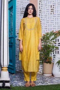 Mustard yellow kurta with multicolor resham embroidery in gold zari taar and sequin, kantha work. Paired with pant and inner.
Components: 3
Pattern: Embroidery
Type Of Work: Resham, zari, sequin, kantha
Neckline: Round
Sleeve Type: Three quarter
Fabric: Kurta: Handloom Chanderi, Pant and Slip: Viscose Silk
Color: Yellow
Other Details: 
Cuff sleeve hem
Front button detailing

Occasion: Work - Aza Fashions Gold Embroidered Sharara In Slub Silk, Gold Embroidered Slub Silk Sharara, Gold Embroidered Palazzo Set For Festivals, Unstitched Palazzo Set With Gold Embroidery For Festivals, Festival Unstitched Palazzo Set With Gold Embroidery, Designer Gold Slub Silk Kurta, Mustard Kurta With Dupatta For Festive Occasions, Festive Mustard Kurta With Resham Embroidery, Gold Embroidered Raw Silk Palazzo Set