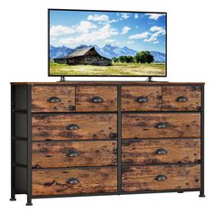 an old wooden dresser with a flat screen tv on top