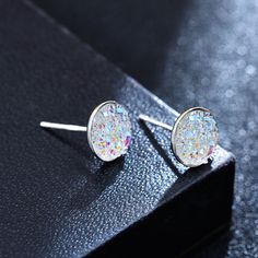 Fancy crystal stud earrings Imitating natural crystal clusters, these crystal earrings studs have a number of tiny protruding crystals on the surface. This makes the 8mm crystal stud earrings have a perfect reflecting surface, glittering from any angle, fascinating like a starry night sky. Thanks to their gorgeous look, these druzy stone stud earrings are perfect for nights out, parties, and dancing. There are up to 11 different colors of drusy stud earrings: opal white, glitter champagne, glitt