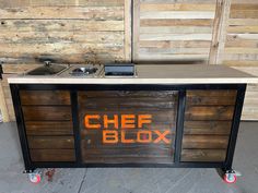 a kitchen island made out of pallets with the word chef blox painted on it