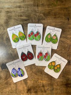 six pairs of earrings are displayed on cards