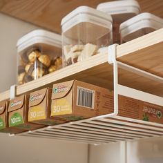 the shelves are filled with different types of food and storage bins for snacks or desserts