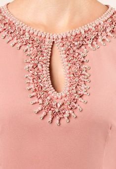 the back of a woman's pink dress with beading on it and an open neck