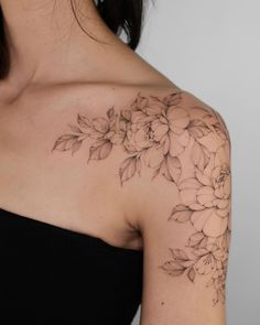 a woman's shoulder with flowers on it