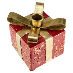 a red and white gift box with gold ribbon tied around the top, on a white background