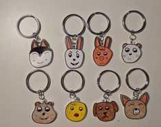 six different key chains with cartoon faces on them