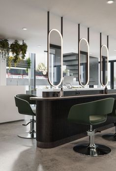 an empty salon with chairs and mirrors on the wall