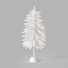 a white christmas tree with lights on it