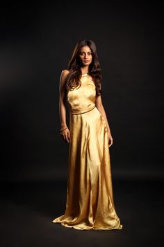 Dress to impress this season with this luxurious golden chardonnay gown! Crafted from cupro satin, its halter neckline adds a touch of opulence that will make you stand out at any soirée. Show off your style and elegance while making an unforgettable entrance with this must-have evening wear!Details Neckline: Halter neck Material: Cupro satin Lining: Cotton-polyester Made in India What makes this outfit sustainable?This outfit is made with cupro satin; the fabric is made from cotton linter waste. It is a sustainable alternative to polyester. Glamorous Satin Halter Neck Dress For Weddings, Luxury Satin Finish Gown For Party, Luxury Satin Finish Party Gown, Champagne Satin Gown For Gala, Glamorous Sleeveless Gown With Satin Finish, Gold Maxi Dress For Night Out, Gold Satin Evening Dress, Gold Satin Evening Dress For Gala, Glamorous Satin Halter Neck Evening Dress