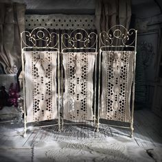 an ornate iron screen in the corner of a room