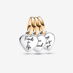 Show them that they mean the world to you with the Pandora Two-tone Splittable Friendship Triple Dangle Charm. Nothing says best friends forever like gifting your besties one part of a splittable charm. Engraved with the messages "Friends for life", "True Friend" and "Always there for you" on each of the hearts, the triple dangle friendship charm is crafted in sterling silver and its bail is in our 14k gold-plated unique metal blend. The two of the pieces are flat on one side and domed on the other, so when placed together, they create a 3D heart shape. Great friends are hard to find, so celebrate yours with a special friendship jewelry piece that represents your bond. - Pandora Two-tone Splittable Friendship Triple Dangle Charm - Sterling silver and 14k Gold-plated unique metal blend Silver Charms For Friendship On Valentine's Day, Engraved Charms For Anniversary, Personalized Silver Charms For Best Friend Gift, Inspirational Silver Jewelry For Best Friend Gift, Friends For Life, Friendship Jewelry, 3d Heart, Fine Jewelry Bracelets, Best Friends Forever