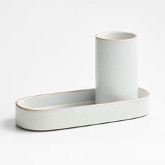 two white ceramic containers sitting on top of each other