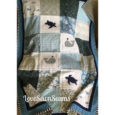 a quilted blanket with an animal design on the front and back, is shown