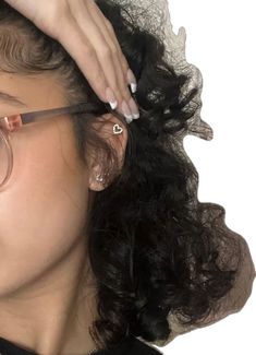 a woman with long hair and glasses is getting her hair styled by another woman's hand