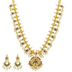 This beautiful 22k yellow gold necklace and Chandbali earring set by Virani Jewelers is a celebration of luxury and tradition. Adorned with rubies, emeralds, pearls, and cubic zirconia, the gold Temple necklace and Chandbali earring set showcases a captivating Indian jewelry design that speaks to the elegance of traditional gold jewelry. Perfect for those who seek a distinctive and sophisticated jewelry set, this gold necklace and earring is a testament to fine craftsmanship and timeless beauty. Luxury Yellow Gold Temple Necklace For Celebration, Yellow Gold Temple Necklace With 17 Jewels For Diwali, 22k Gold Temple Jewelry Emerald Necklace For Celebration, Temple Jewelry Sets In Yellow Gold For Celebrations, Bollywood Style Yellow Gold Temple Necklace For Celebrations, Festive 22k Gold Emerald Necklace For Celebration, Yellow Gold Kundan Temple Jewelry Necklace For Celebration, Yellow Gold Kundan Necklace For Celebrations, Bollywood Temple Necklace With 17 Jewels For Festivals