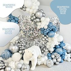 a white polar bear surrounded by blue and silver balloons