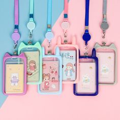 several different colored tags with cartoon characters attached to them on a pink and blue background