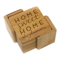 a wooden coaster with the words home sweet home written in cursive writing on it