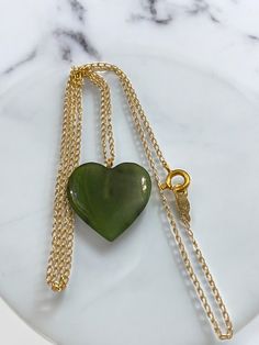 Vintage 14k Gold Green Jade HEART 15" Good Luck Pendant 15" Cable Chain Necklace * Beautiful jade heart charm pendant with 14K gold 15" chain! * Chain has a secure spring ring closure. * The color of the jade is beautiful green hue. * Measurements: Jade heart pendant measures approximately 5/8" high. * Total Weight: 1.6 grams! * Condition: Beautiful vintage condition. Please carefully review all photos :) Ships FAST AND FREE, insured mail :) I guarantee item to be as described and pictured : ) Green 14k Gold Heart Jewelry, Green Heart-shaped 14k Gold Jewelry, Green Necklace With Heart Charm For Anniversary, Green Heart Charm Necklace For Anniversary, Green 14k Gold Heart Pendant Necklace, Cable Chain Necklace, Jade Necklace, Vintage Heart, Green Jade