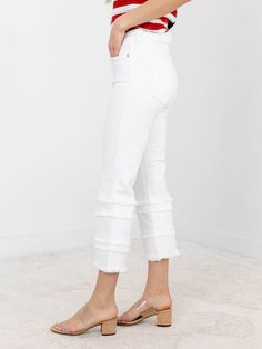 A more trend forward take on denim for the summer season! These unique and updated denim jeans feature a cropped length and flared leg opening, adding an extra touch of style to your look. The frayed tiered design and crisp white wash give them a trendy edge that will make you stand out in any crowd. Elevate your wardrobe today! A fun way to update a classic look. Liverpool Cropped length Frayed tiered accents Crisp white coloration 69% Cotton, 24% Modal, 6% Polyester, 1% Elastane Rise: 8.5" Ins Chic Flared Jeans With Frayed Hem, Summer Flare Jeans With Frayed Hem, Summer Flare Pants With Frayed Hem, Stretch Cropped Bottoms With Frayed Hem, White Mid-rise Flare Jeans With Frayed Hem, White High Rise Flare Jeans With Frayed Hem, White High-rise Flare Jeans With Frayed Hem, White High Rise Stretch Cropped Jeans, Spring Cropped Jeans With Frayed Hem